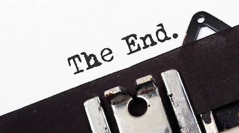 Retro typewriter text the end on white paper