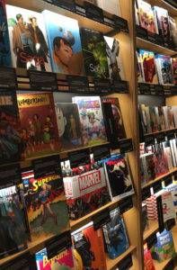 A wall of shelves containing graphic novels with their covers facing outward