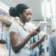 black woman reading book subway