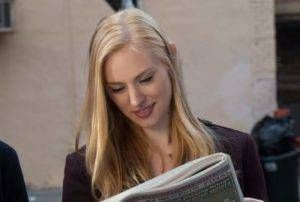 Karen Page (played by Deborah Ann Moll) is reading a newspaper 