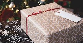 A gift wrapped box tied with a red ribbon.