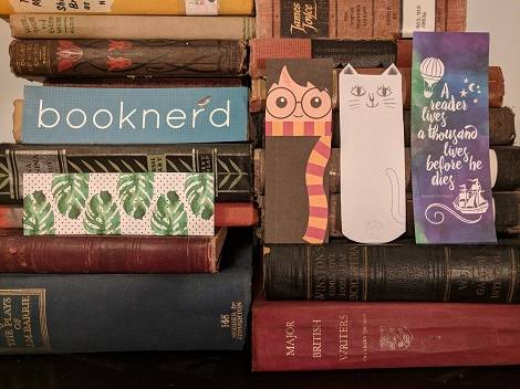 Printable bookmarks displayed on a stack of books