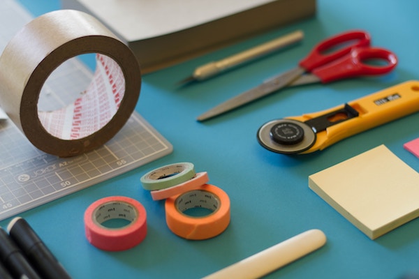 photo of tape, scissors, and other craft supplies laid out