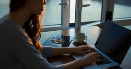 photo of woman writing on laptop