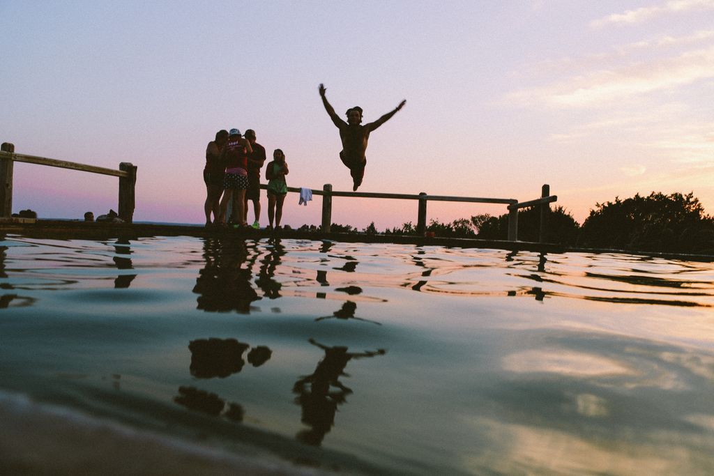 People Jumping Into Pool