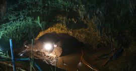 Photo of entrance to cave with spotlight shining