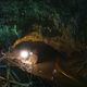 Photo of entrance to cave with spotlight shining