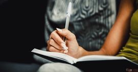woman writing in notebook, book signings
