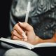 woman writing in notebook, book signings