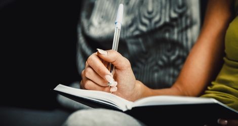 woman writing in notebook, book signings