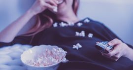 bookish tv shows woman eating popcorn television feature