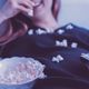 bookish tv shows woman eating popcorn television feature