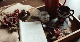 Photo of a book on a tray with tea and sugar