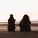 kids talking with their backs to the camera on the beach feature 470x248