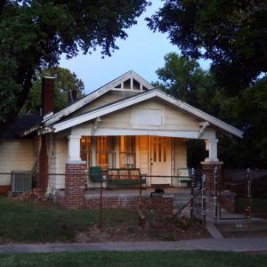 The somewhat dilapidated tan and brick bungalow where the Curtis brothers lived in The Outsiders movie