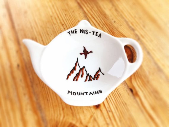 tea spoon rest with a painting of the "Mis-Tea" Mountains
