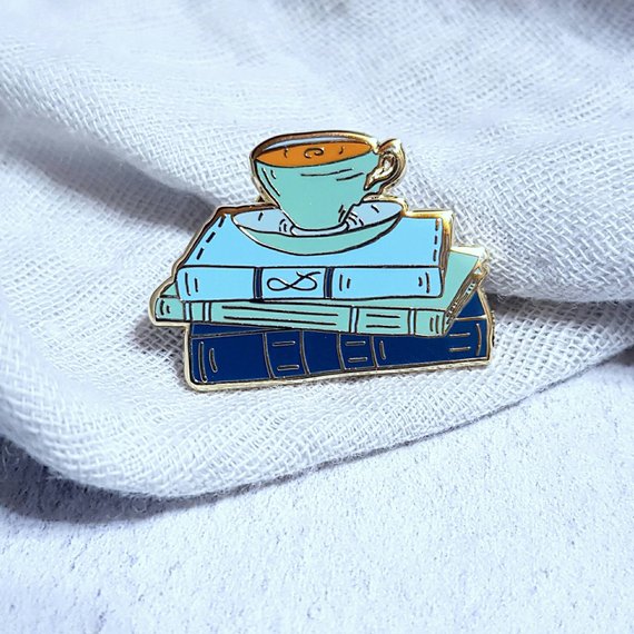 teacup on a stack of books enamel pin