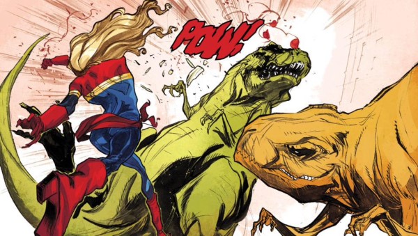 Captain Marvel punches a dinosaur