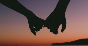 forbidden love romance holding hands feature