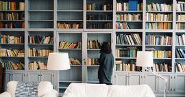 Woman looking at shelf of books