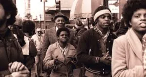 Members of Peoples Temple including Richard Parr, Wesley Johnson, Barbara Hickson, Ricky Johnson and Sandra Cobb attend an anti-eviction rally at the International Hotel, 848 Kearny Street in San Francisco, January 1977. Photo by Nancy Wong CC BY-SA 4.0