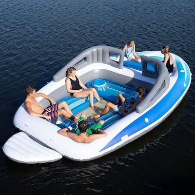Image of people sitting in a beach float shaped like a speed boat.
