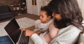child and mother looking at a laptop feature