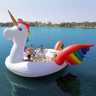 Image of people sitting in a giant unicorn-shaped beach float.