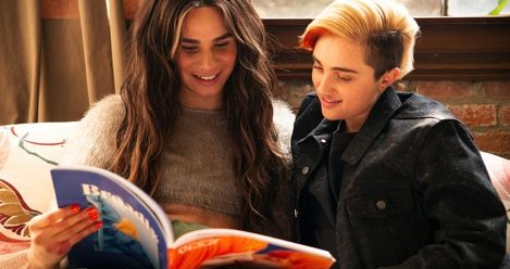 trans couple reading colorful book queer lgbtq feature
