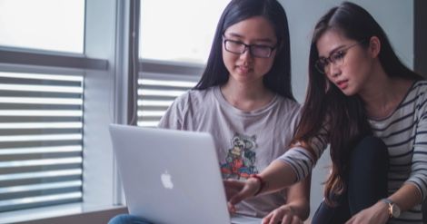 young women teen girls looking at laptop girls who code feature