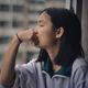 young woman looking out the window feature