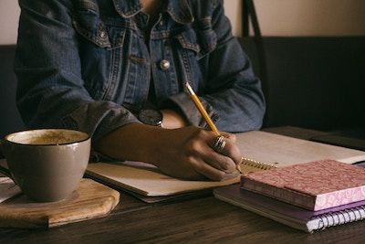 woman-writing-on-notepad