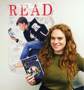 Anna James posing in front of our David Bowie Poster