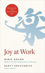 cover of Joy At Work by Marie Kondo:light grey-blue Japanese alphabet character a cream background plus the title of the book in red text