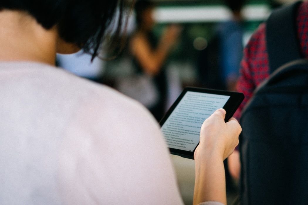 image: person using ereader (source: unsplash)