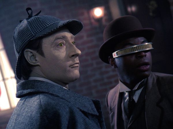 Commander Data and Lt. Geordi La Forge dressed as Holmes and Watson. Image source: https://memory-alpha.fandom.com/wiki/Elementary,_Dear_Data_(episode)