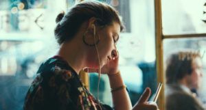 a photo of someone listening to headphones at a cafe or library
