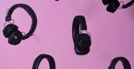 headphones against a pink background