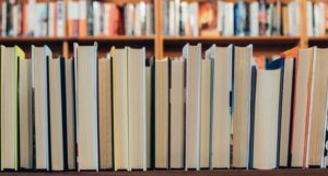 a photo of a shelf of books seen from behind