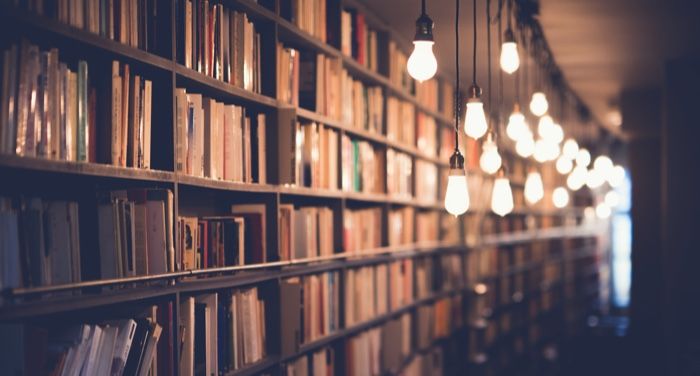 a photo of a bookstore lit up with hanging lightbulbs