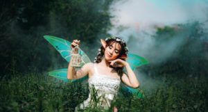 woman dressed as a fairy in a meadow