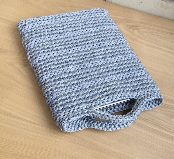 neutral grey crochet book sleeve with handles