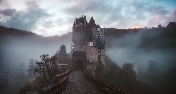 a photo of a castle through fog