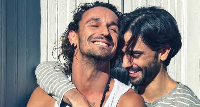 gay men smiling and embracing