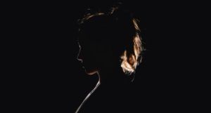 side profile of a woman in black silhouette