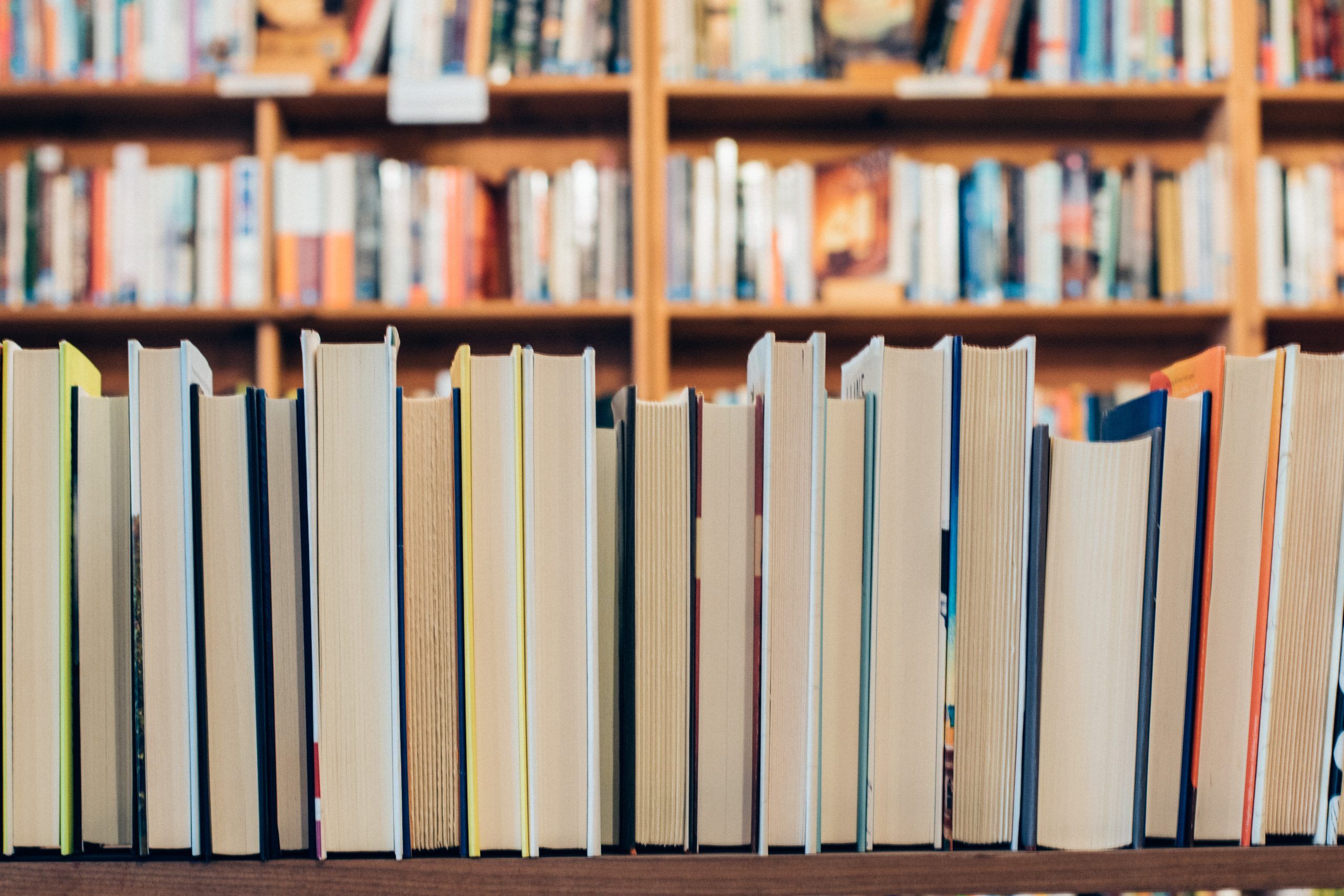 a photo of a shelf of books with the spines faced away from the camera