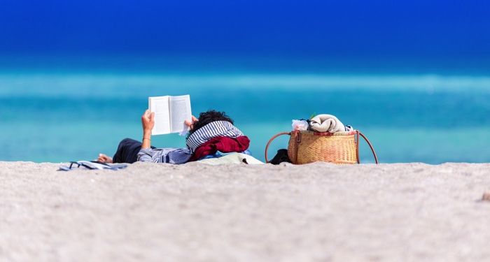 person reading at the beach