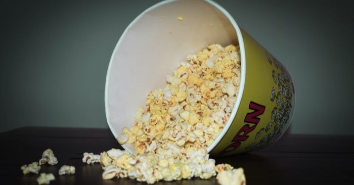 a photo of a spilled bucket of popcorn