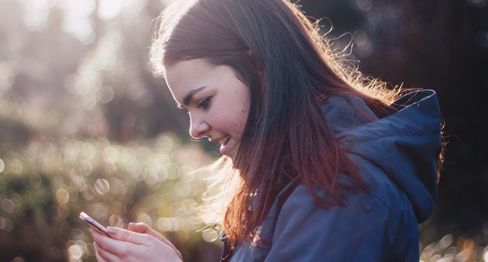 a photo of a woman looking at her phone