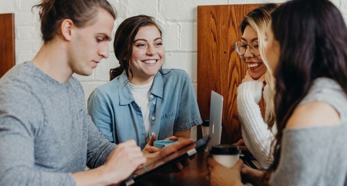 a photo of people talking and laughing together at a table